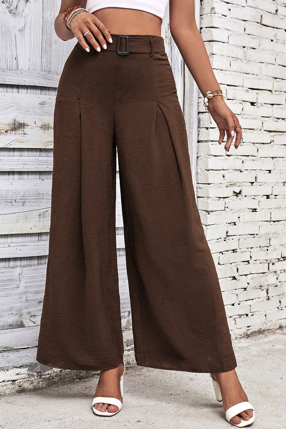 High-waisted wide-leg pants in dark brown with front pleat and belt loops.