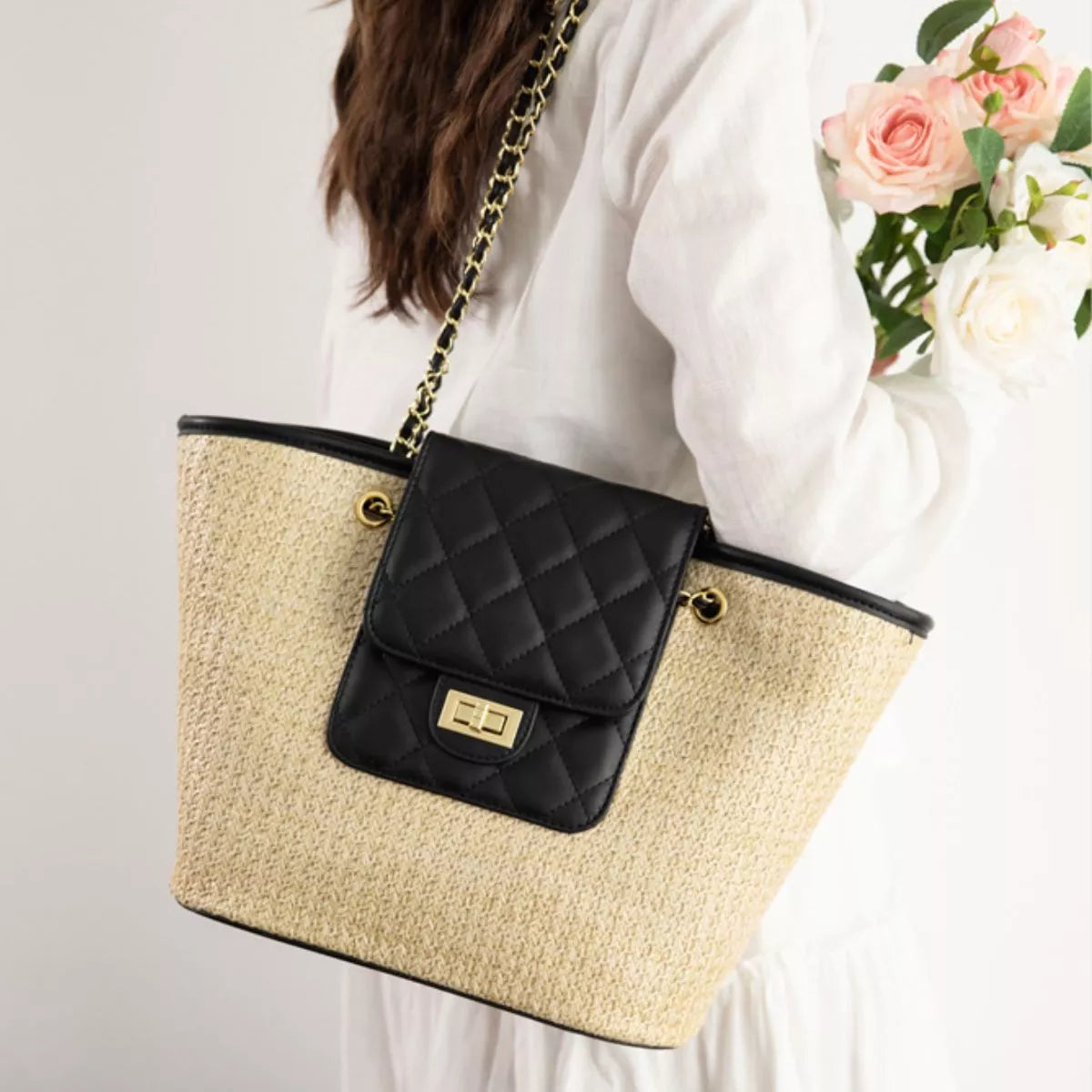 Woven straw shoulder bag with black quilted mini flap pocket and gold-tone hardware