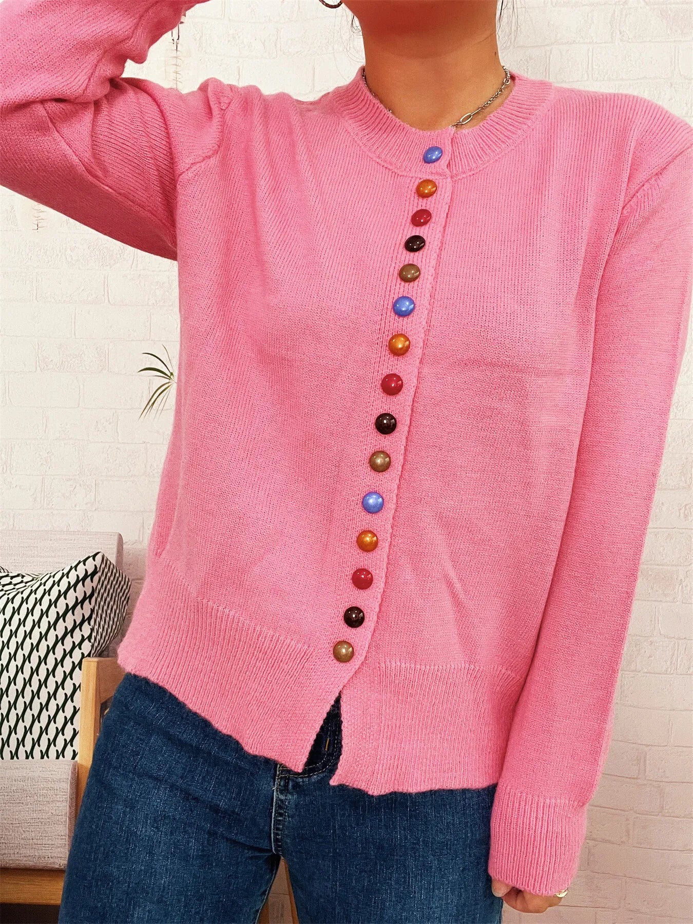 Pink button-front cardigan sweater with crew neck and colorful button placket