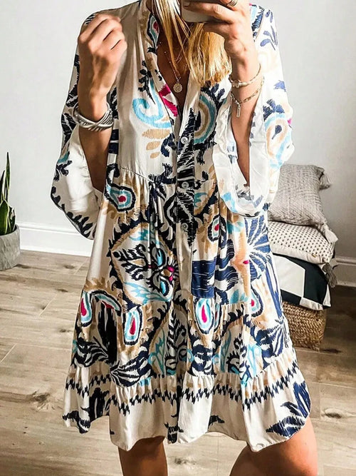 Bohemian print tiered mini dress with long sleeves, white base and blue patterns