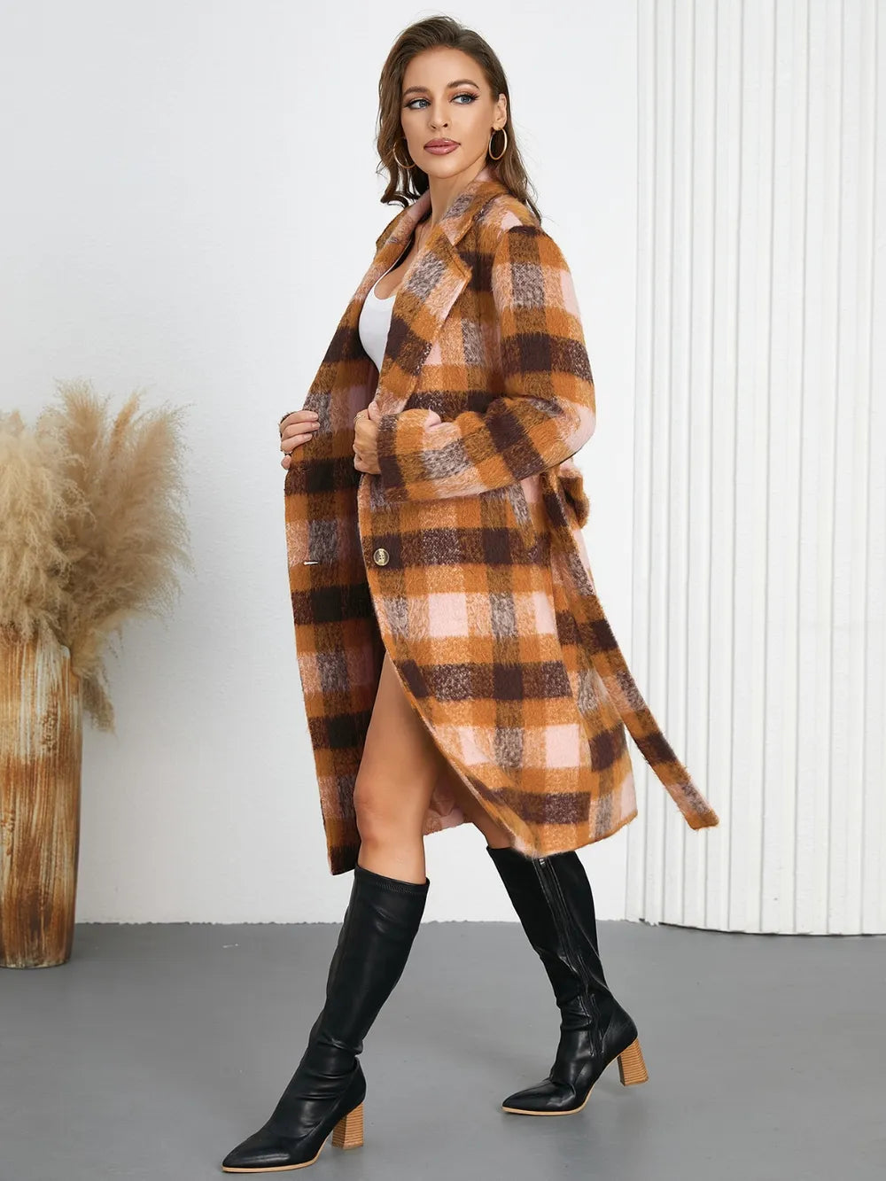 Plaid collared neck coat with waist tie belt, long sleeves, side view with slit hem.
