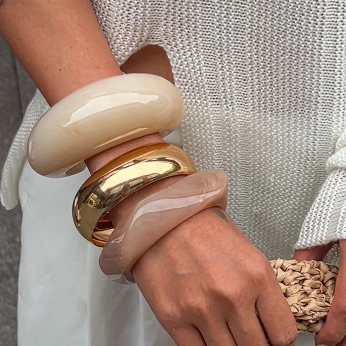 Chunky resin bangles set: cream cuff stacked with blush and gold-tone band