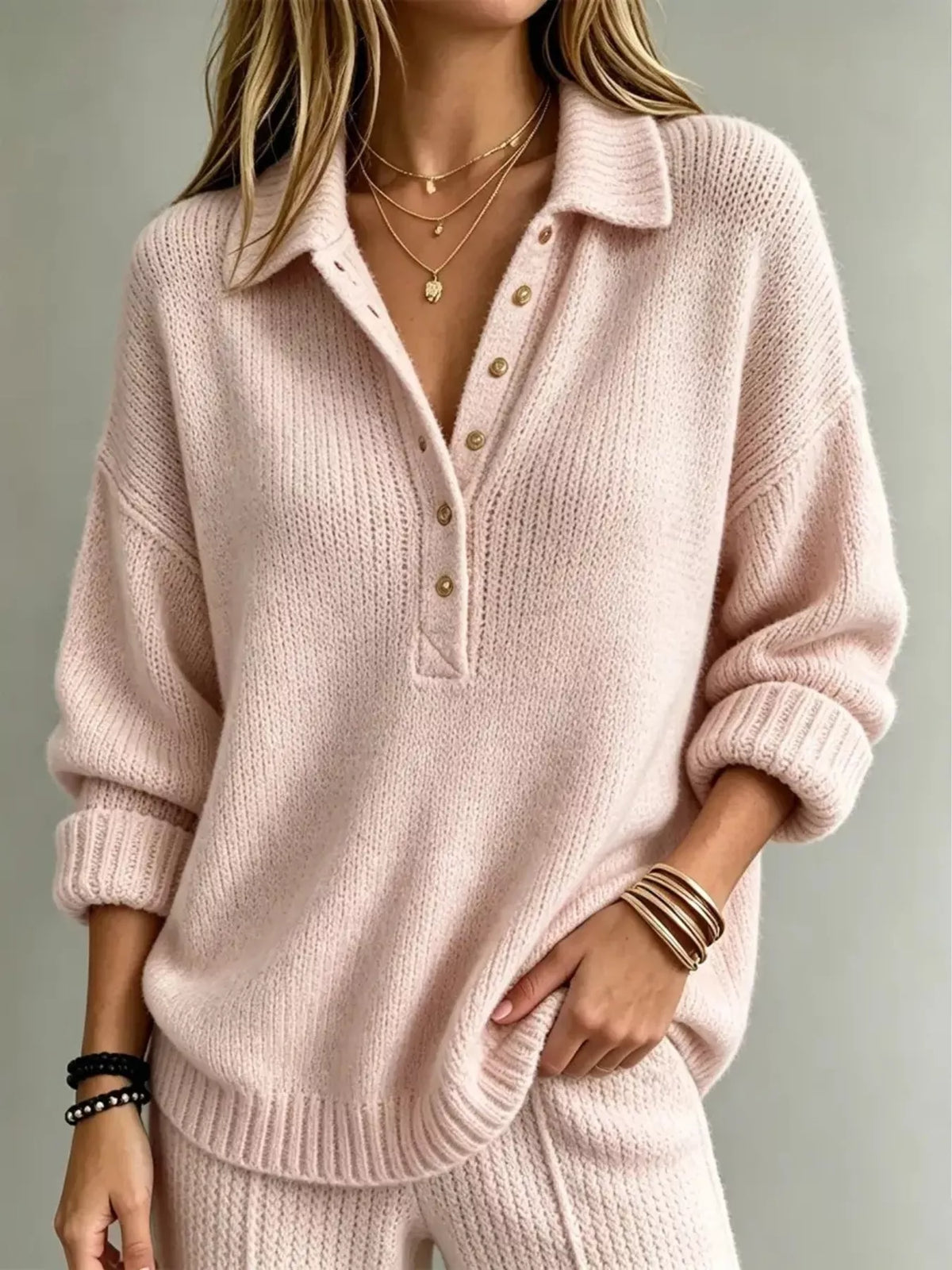 Pink button-front dropped-shoulder sweater with polo collar and gold-tone buttons.