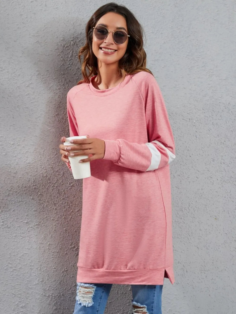 Pink long-sleeve t-shirt with round neck and white striped cuffs