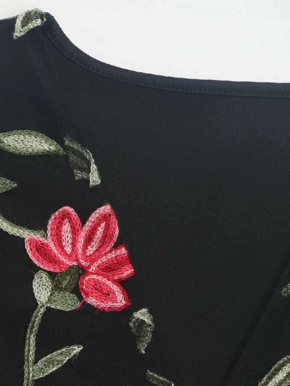 Black bodysuit with close-up floral embroidery on V-neck front panel