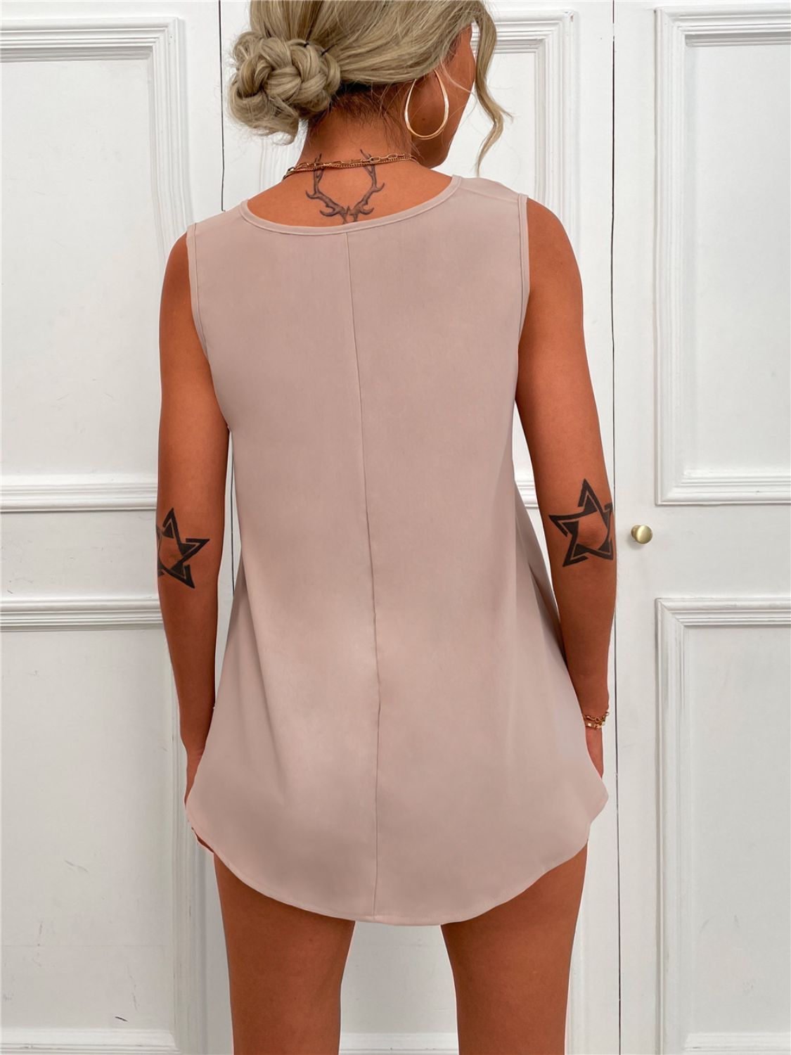 Apricot sleeveless tunic tank with V-neck and curved back hem