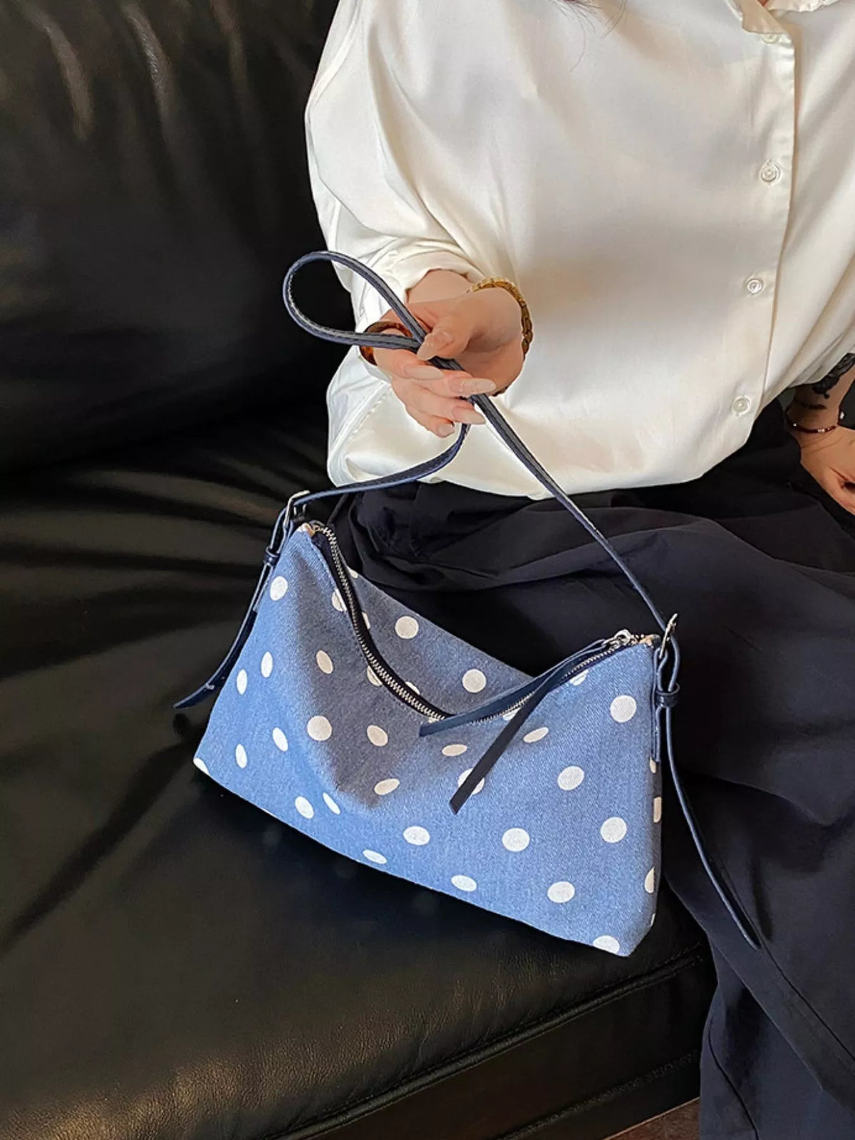 Blue polka dot shoulder bag with zipper closure and two strap handles