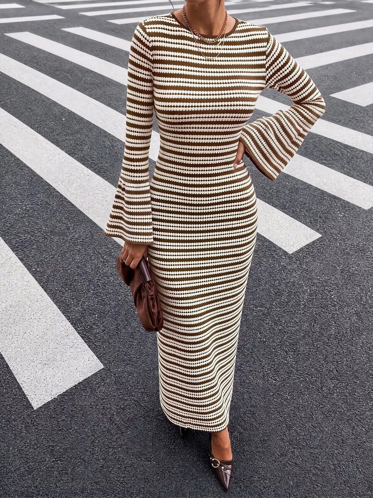 Brown striped ribbed knit midi dress with fitted waist and flared sleeves, side view