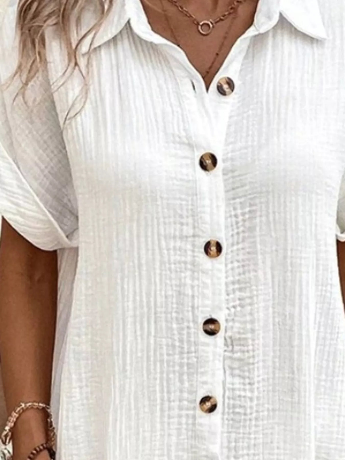White textured shirt dress close-up: button placket and short-sleeve collar
