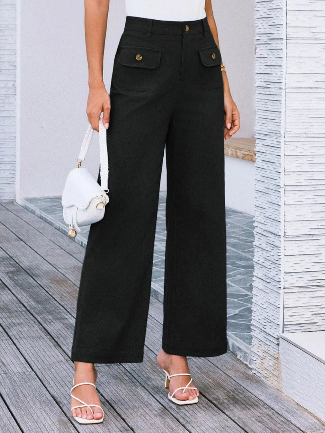 High-waist wide-leg pants, black; wide legs with flap pockets and gold buttons.