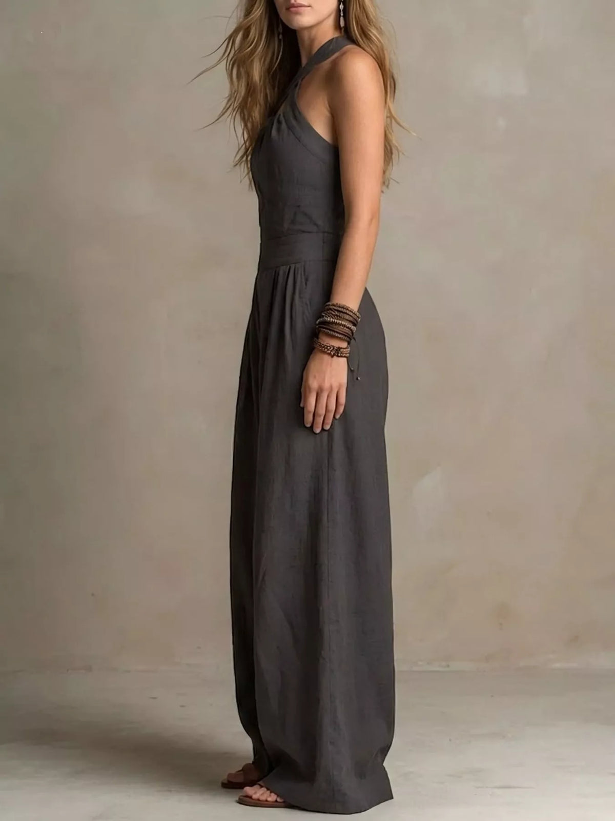 Charcoal halter linen jumpsuit with high waist and wide legs, side view