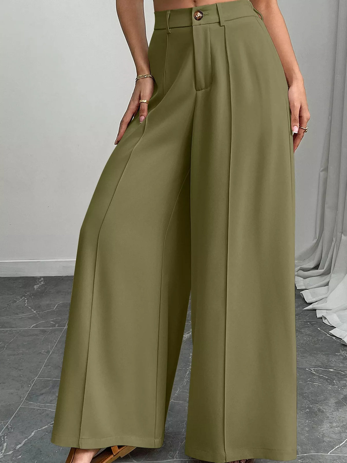Olive green high-waisted wide-leg relaxed pants with button waistband and front pleats