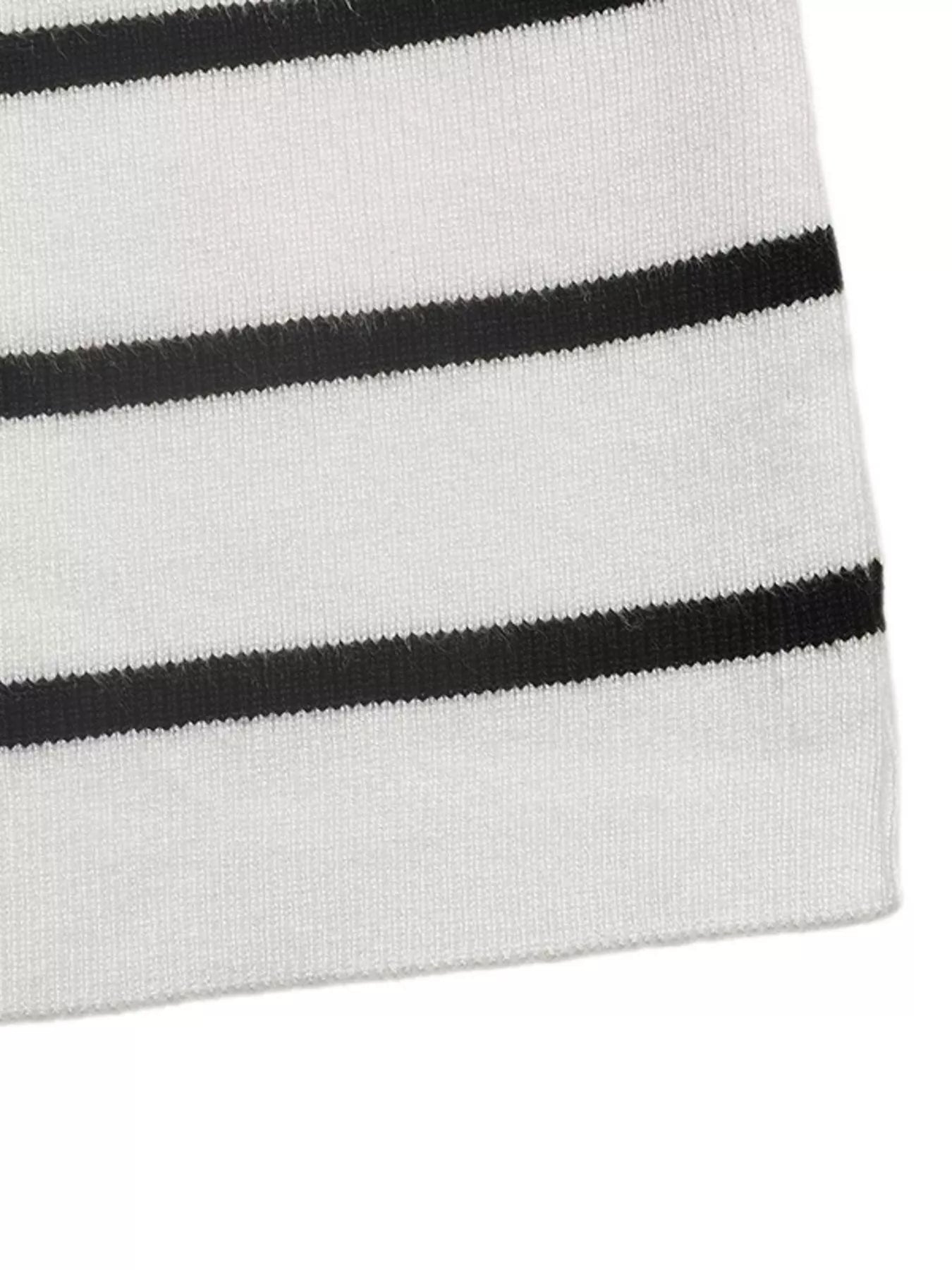 White sweater hem with black horizontal stripe banding in rib knit texture
