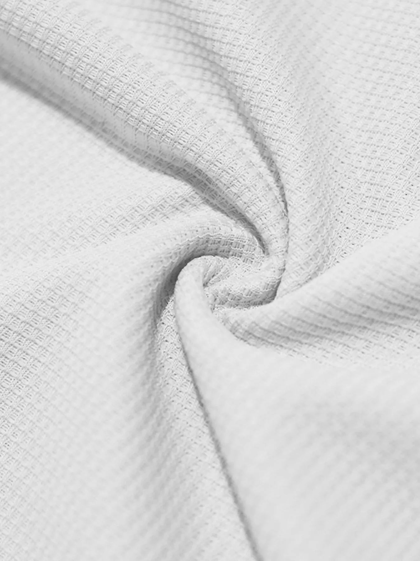 White knit fabric for a top and shorts set, textured close-up