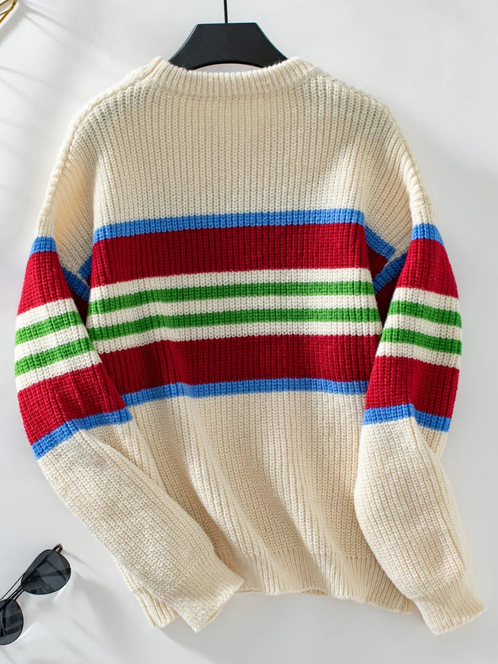 Cream round-neck striped sweater back view on a hanger, long sleeves