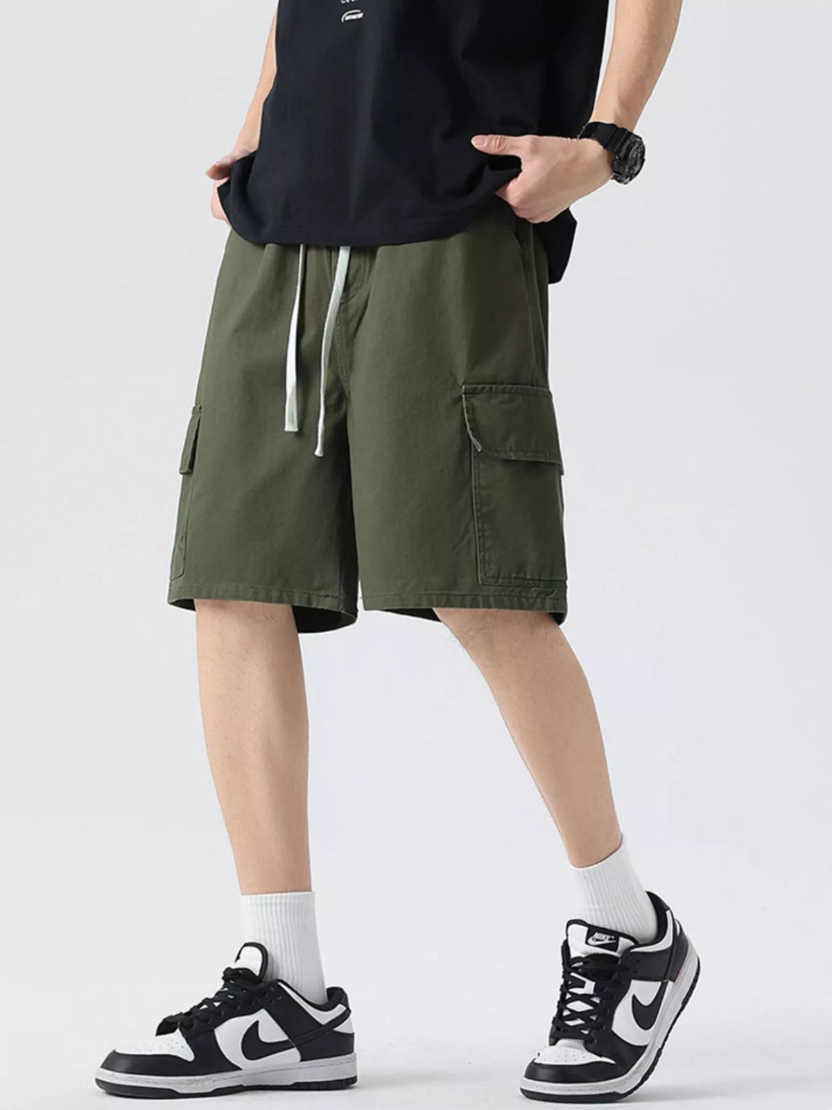 Men's military green cargo drawstring shorts with side pocket and adjustable drawstring.