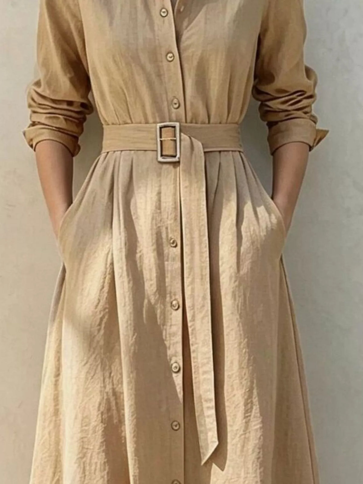 Tan belted midi shirt dress with button placket and bow-like front tie
