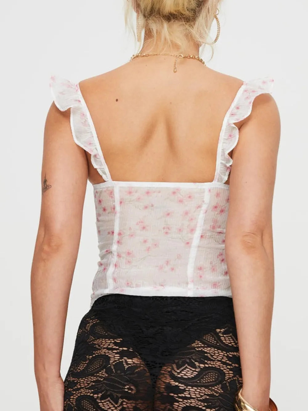 Back view of white floral ruffled square-neck cami with frilled shoulder straps