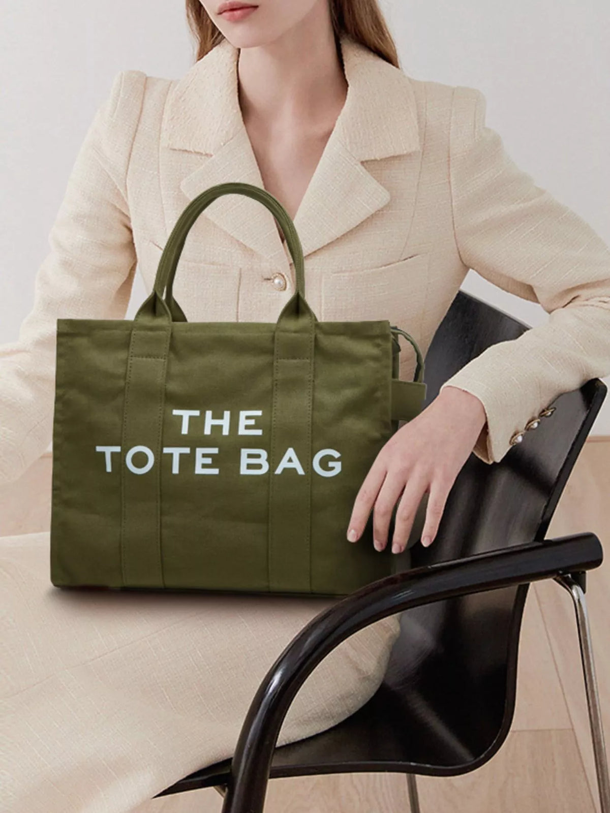 Army green canvas tote bag with “THE TOTE BAG” graphic and structured top handles