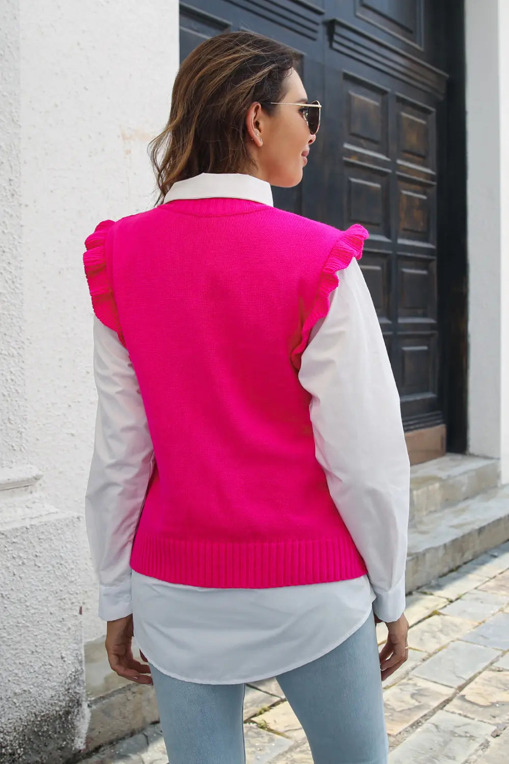 Pink ruffled sweater vest with round neck, knit ribbed hem and shoulder ruffles