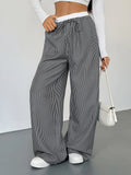 Striped wide-leg drawstring pants with elastic waistband, black and white vertical stripes