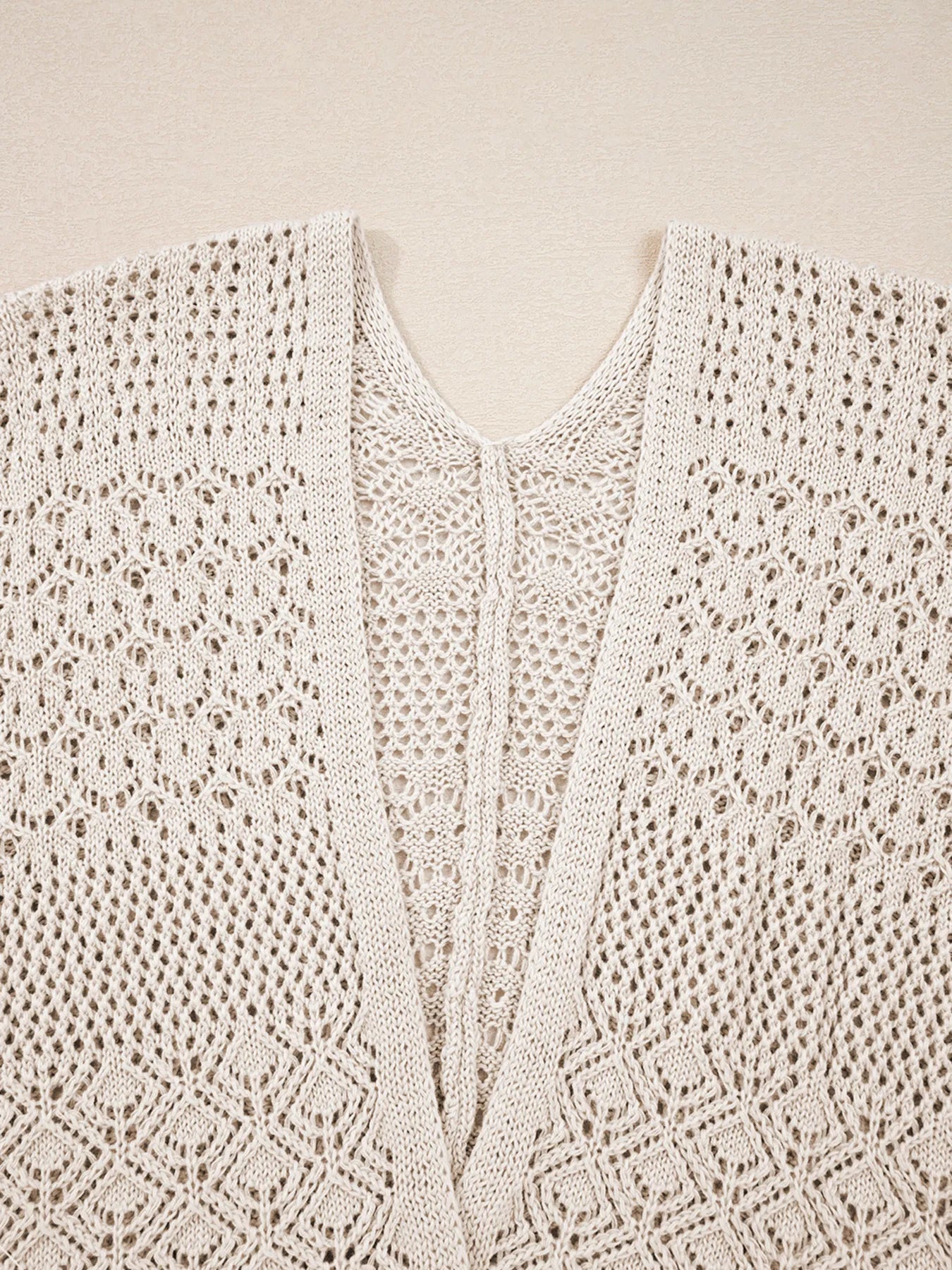 Beige open-front cardigan neckline with lace crochet texture and V seam