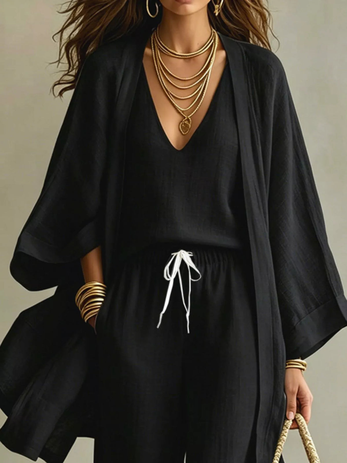 Black V-neck top and drawstring pants with flowy open cardigan, cropped chest view