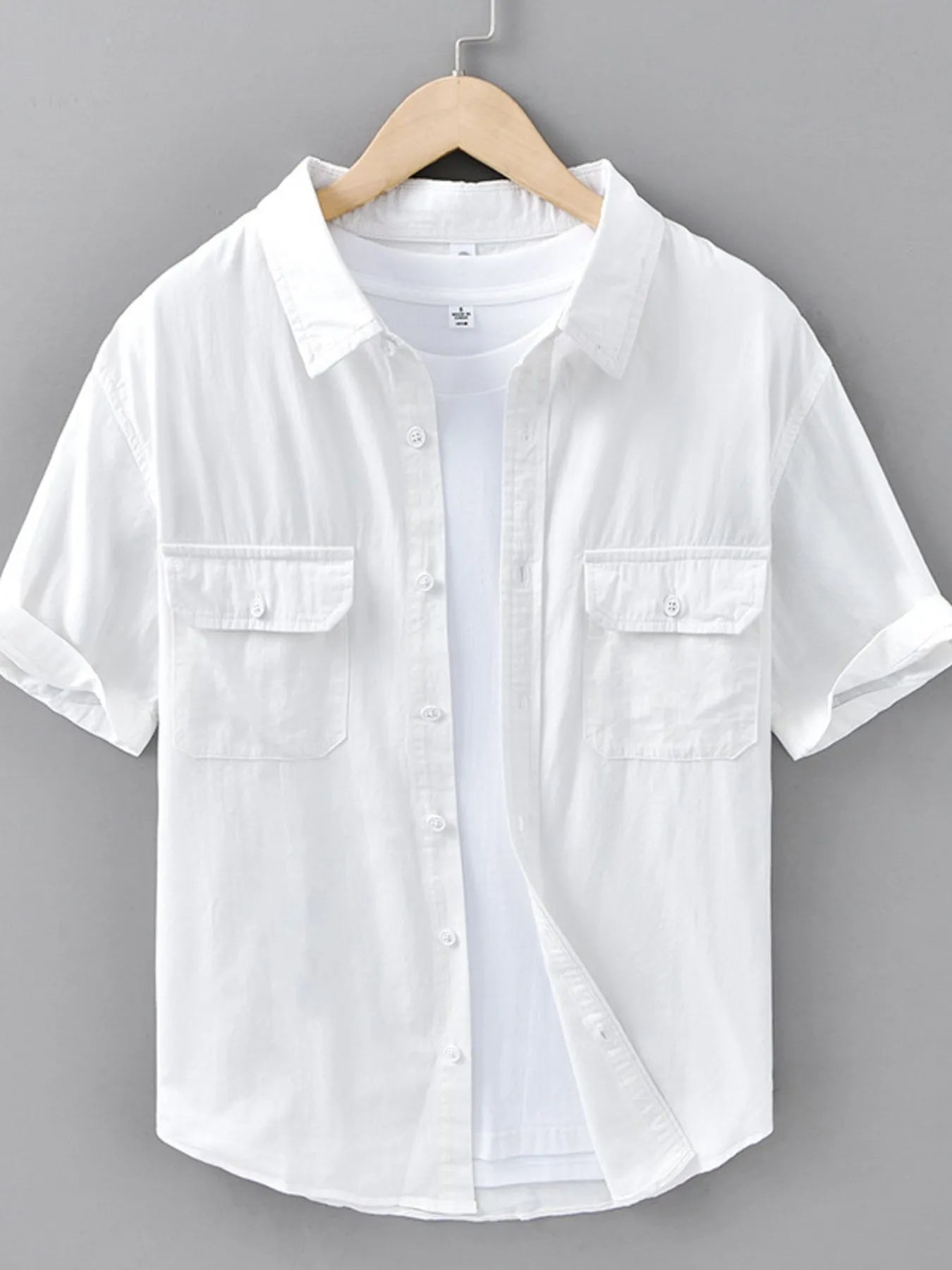 White short-sleeve button-up shirt with chest flap pockets and front buttons