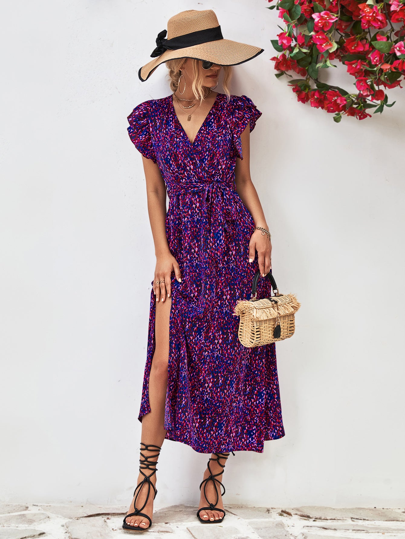 Purple printed surplice neck flutter sleeve slit dress front view with side slit and flutter sleeves.