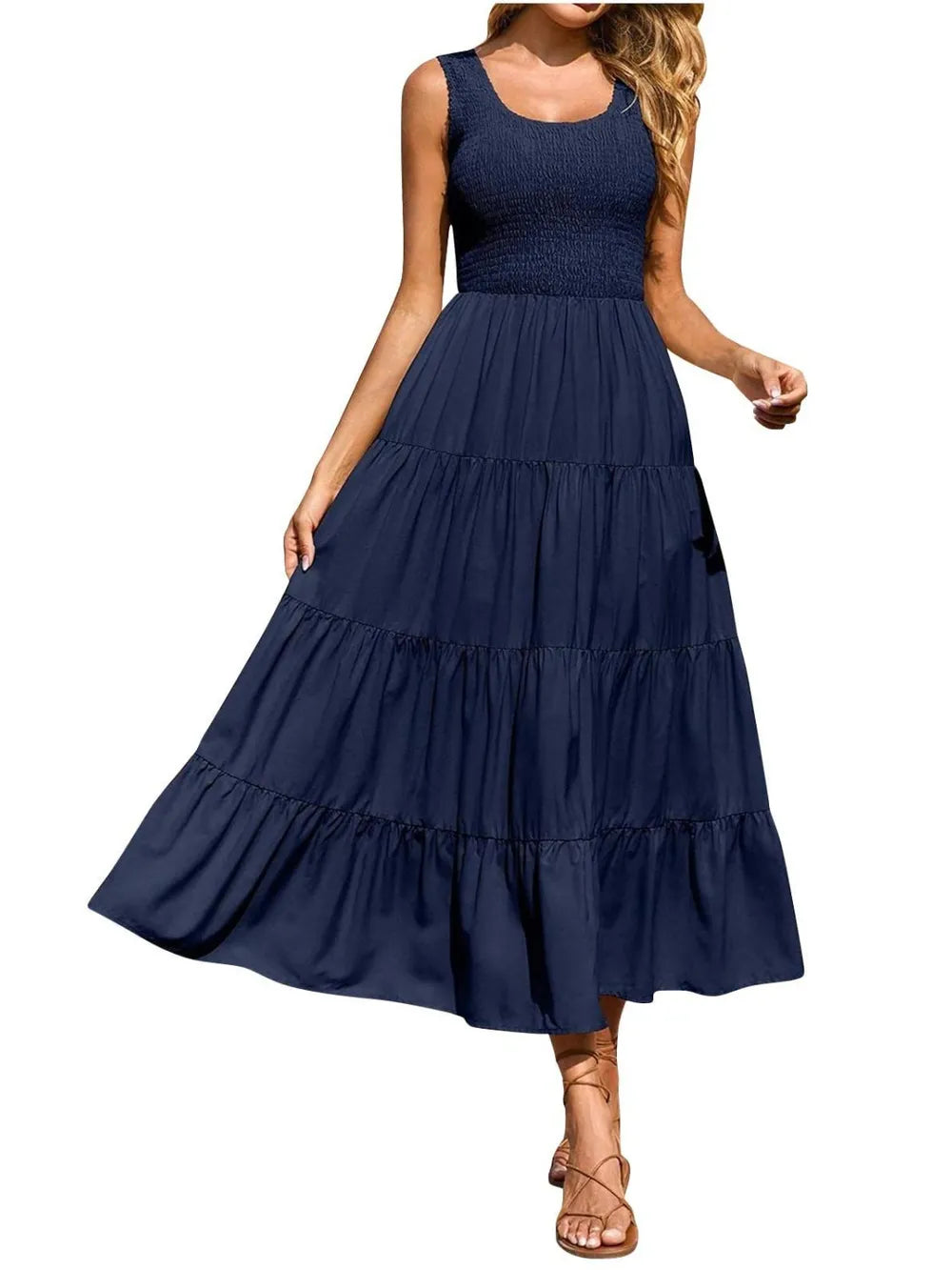 Tiered smocked wide strap dress in dark blue with tiered ruffle skirt.