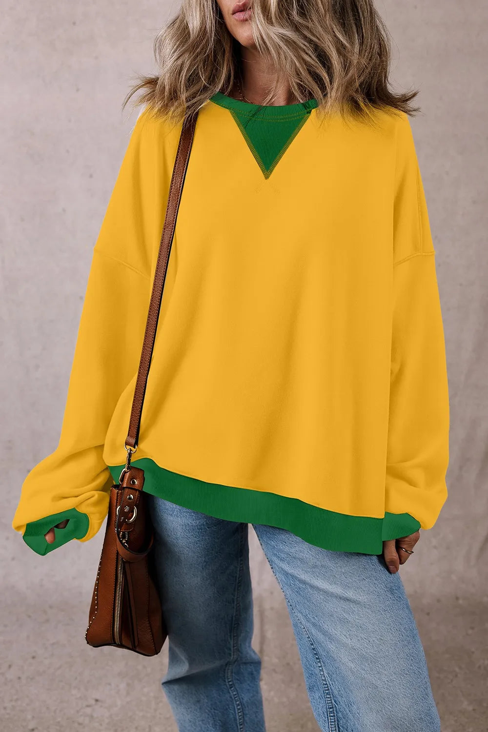 Yellow long-sleeve sweatshirt with green contrast round neckline and matching hem band