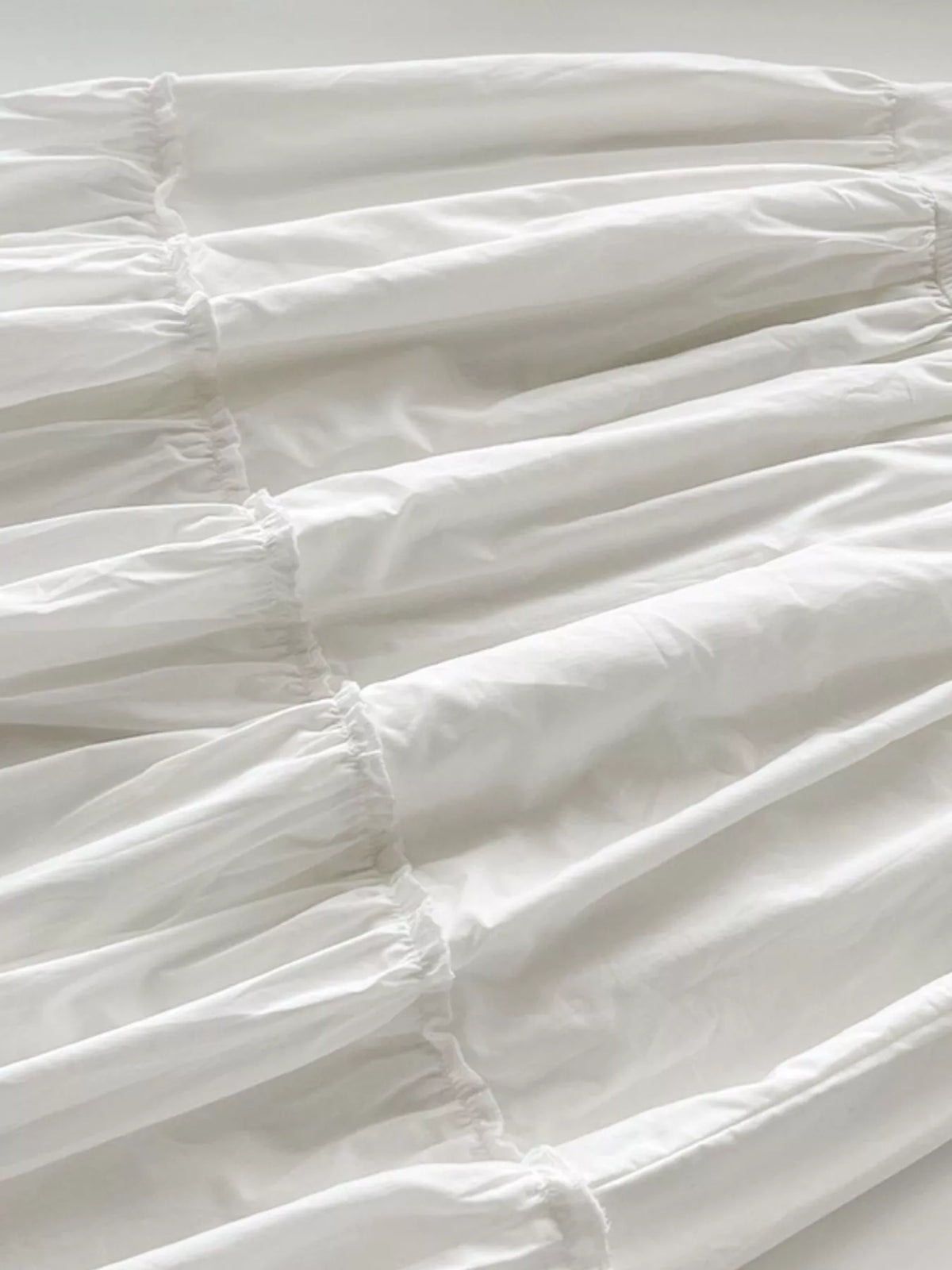 White ruffled square-neck tiered cotton maxi dress, ruched bodice and layered skirt
