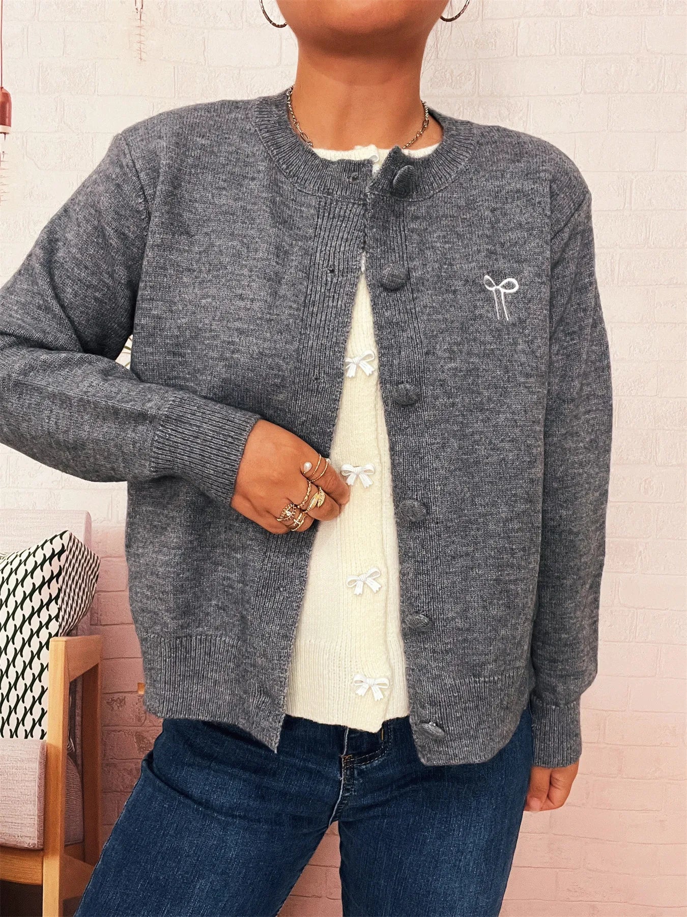 Charcoal gray button-up long sleeve cardigan with knit texture and button front.
