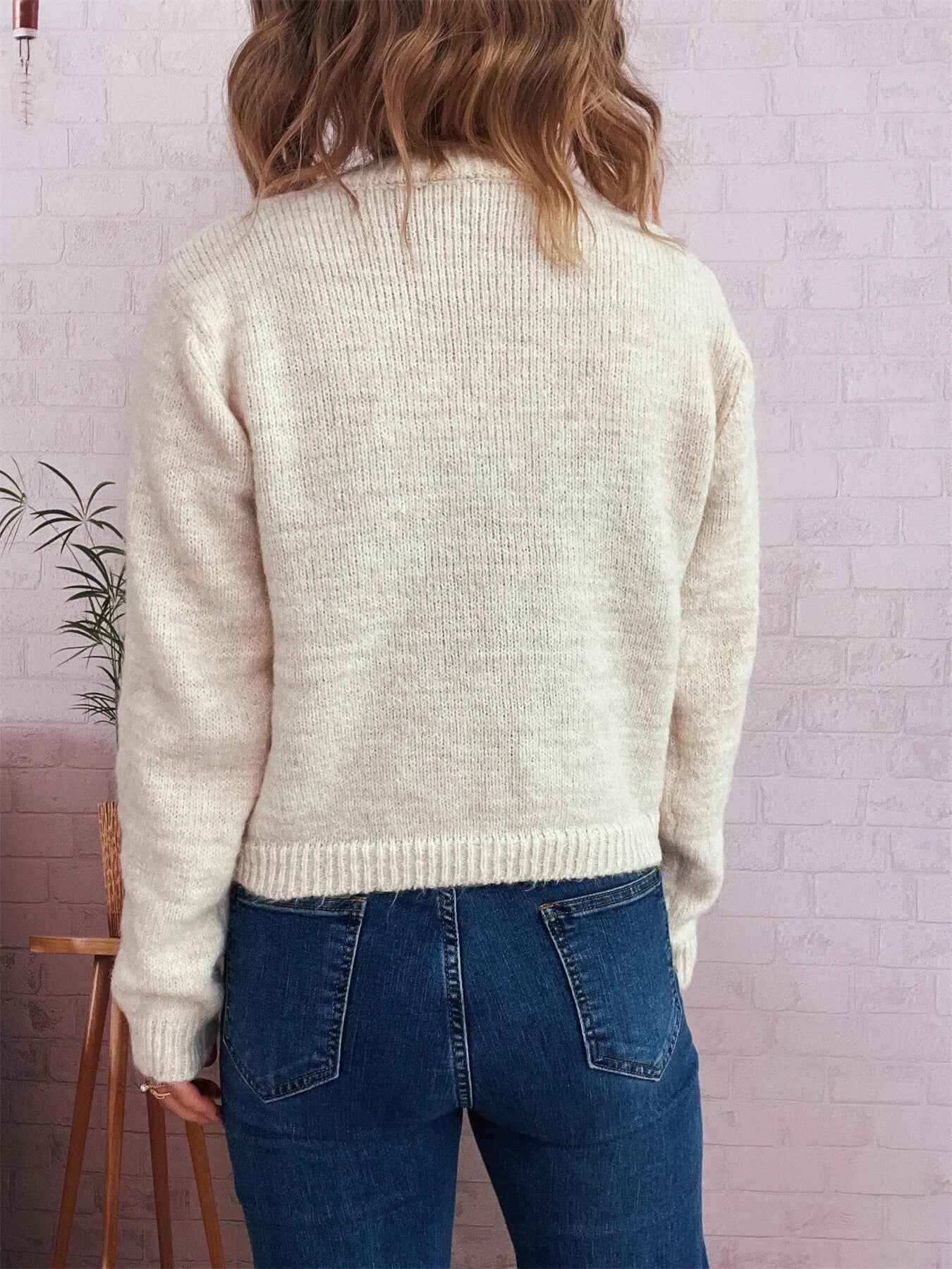 Cream ribbed hem cardigan, back view with full sleeves and knit texture