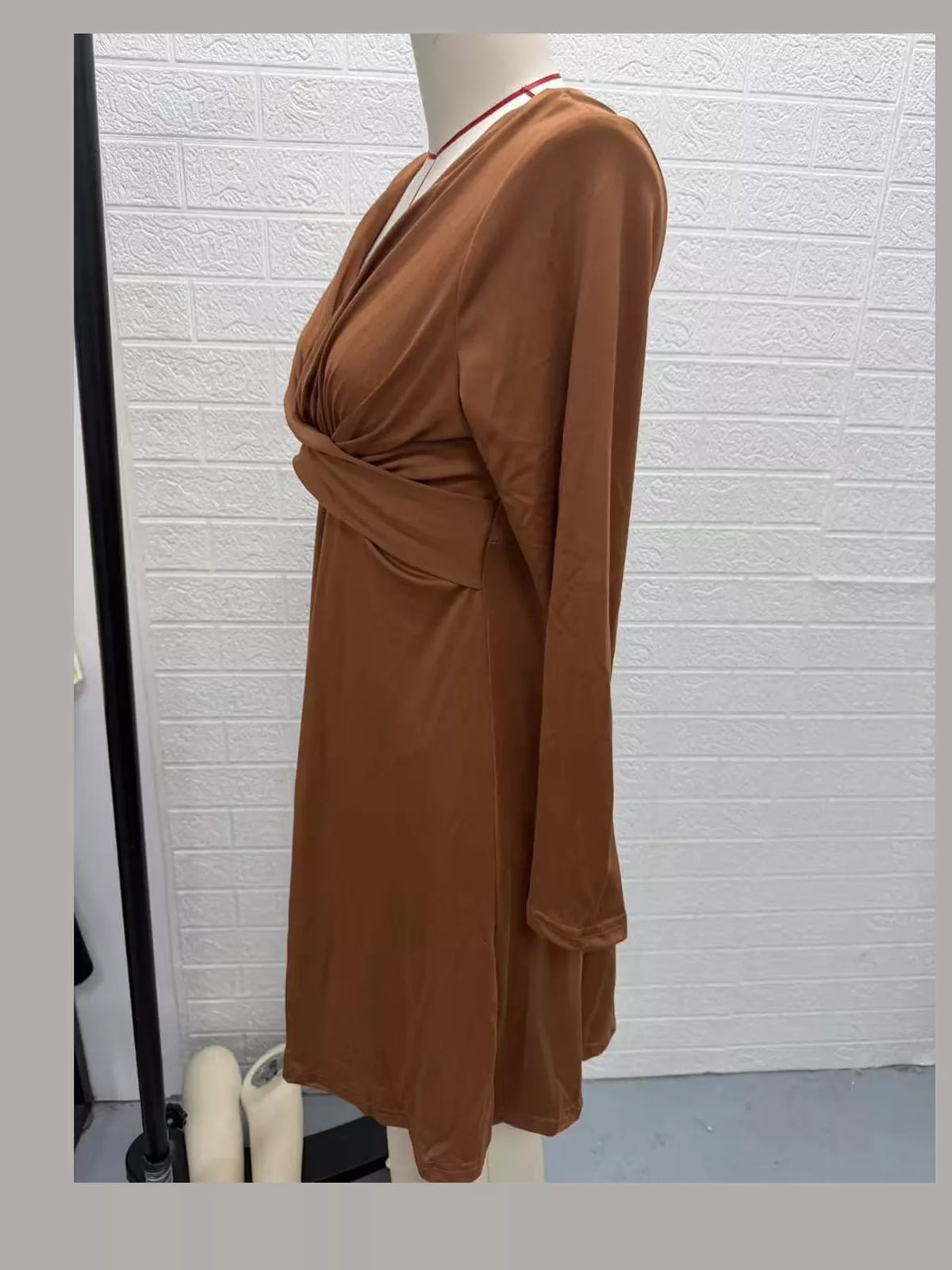 Tan ruched midi dress side view with V-neck, long sleeves, and gathered waist.