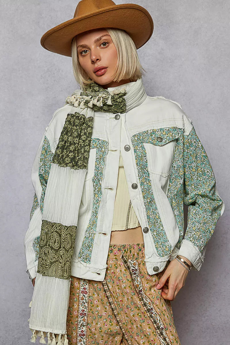 Off-white patchwork denim jacket with green floral panels, button front, chest pockets