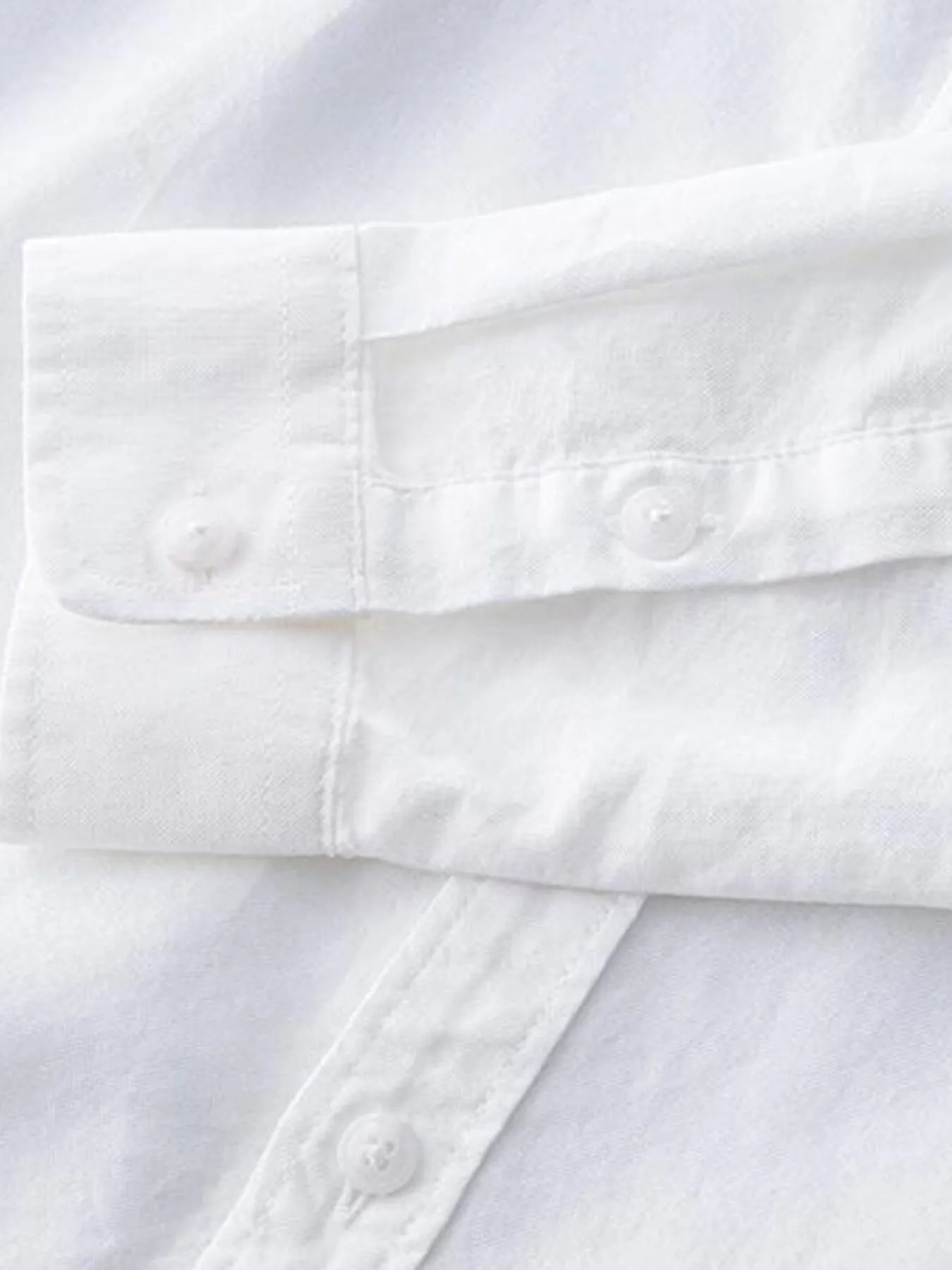 Plus size button-up long sleeve shirt cuff and sleeve placket detail, white with buttons
