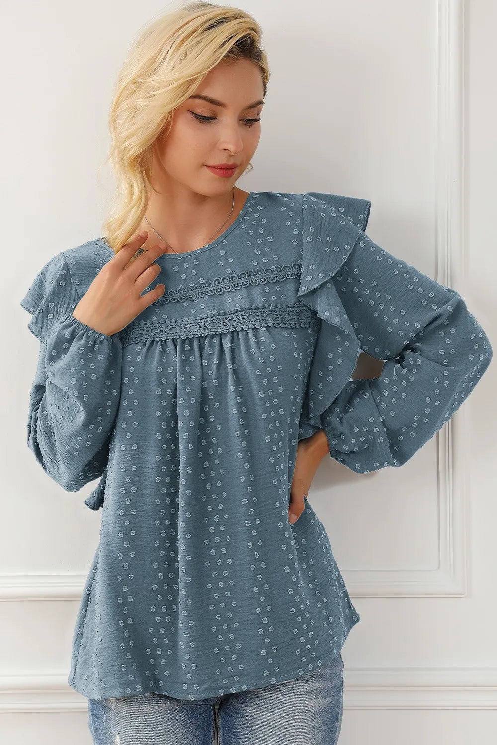Blue round-neck ruffled blouse with flutter ruffles and gathered waistline