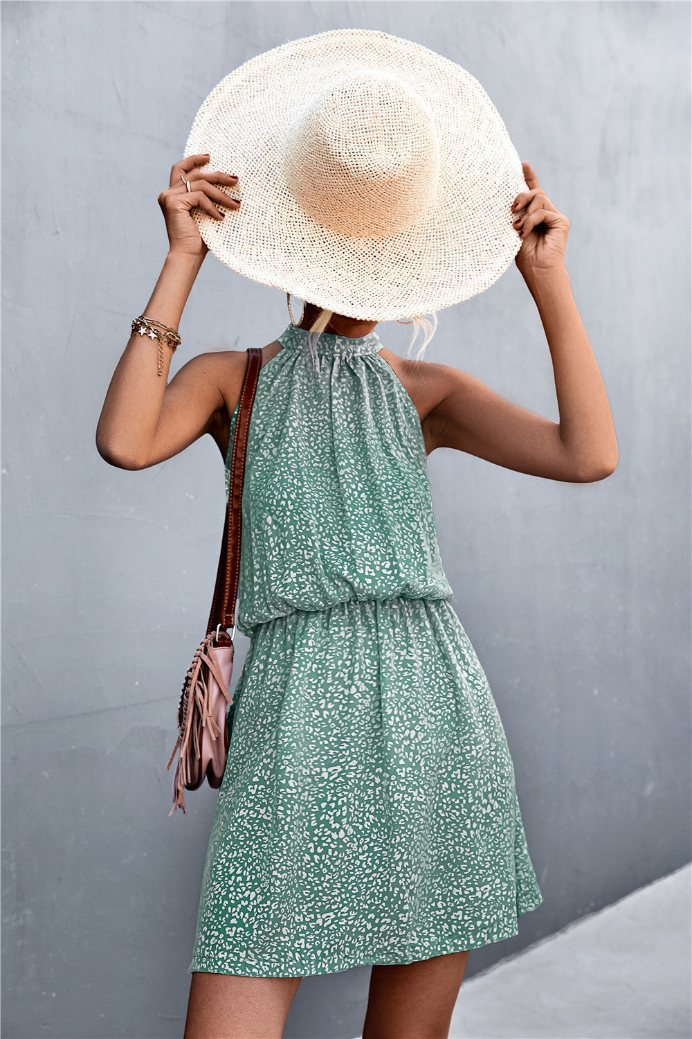 Floral tied sleeveless mini dress in green with gathered waist and halter neckline