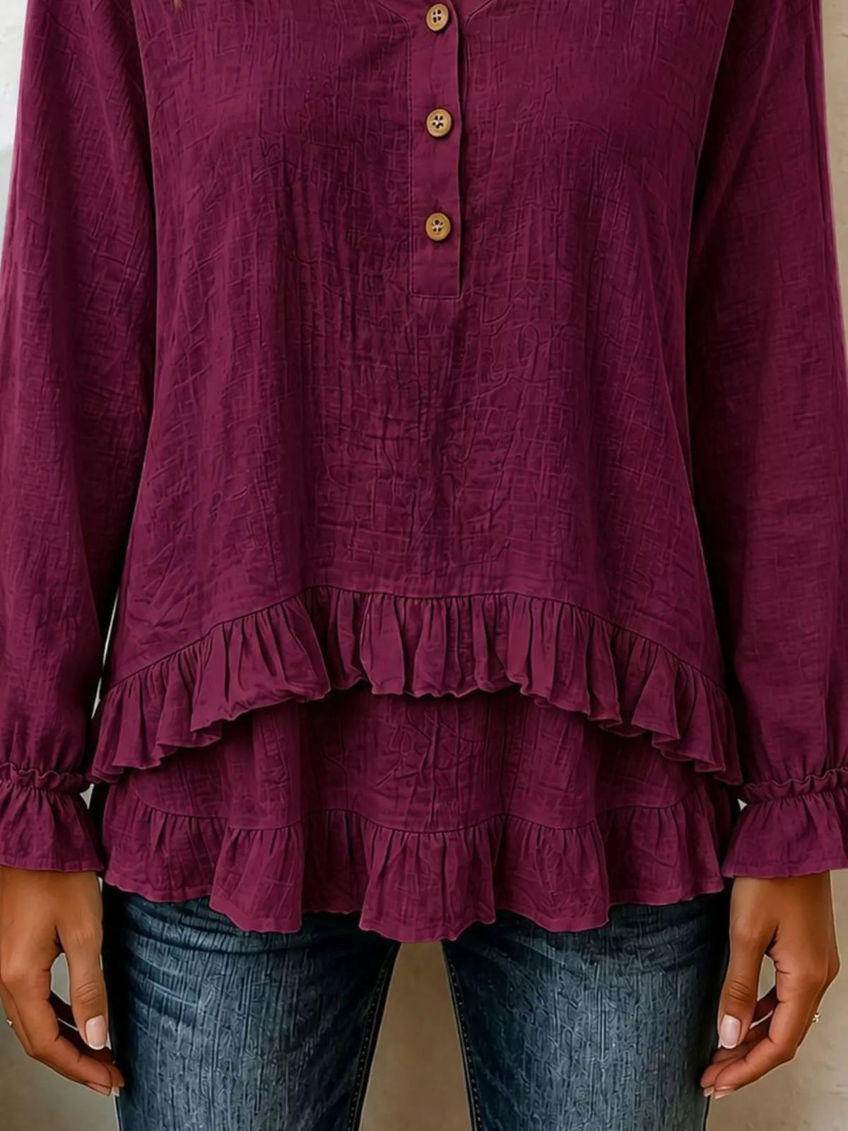Burgundy long-sleeve blouse with tiered ruffle hem and round button front