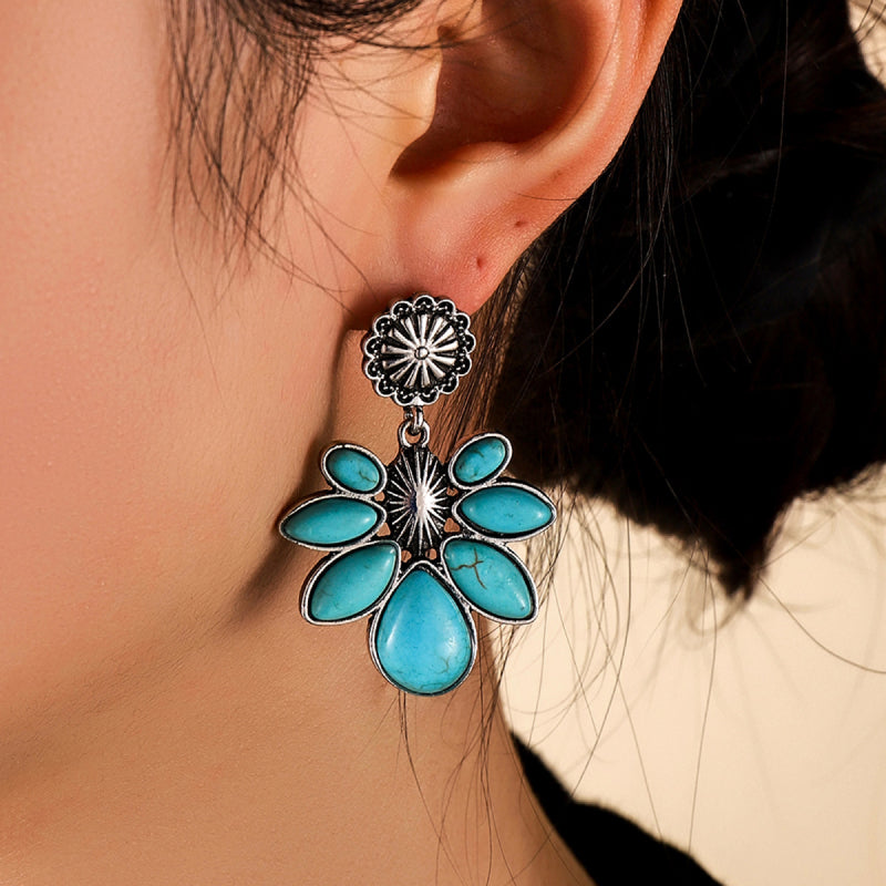 Turquoise flower drop earrings with oval turquoise petals and a silver-tone sunburst top.