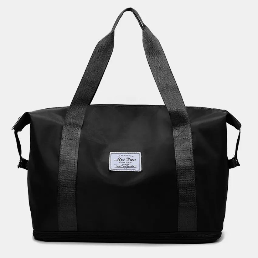 Black large duffle bag with long handles and front patch label