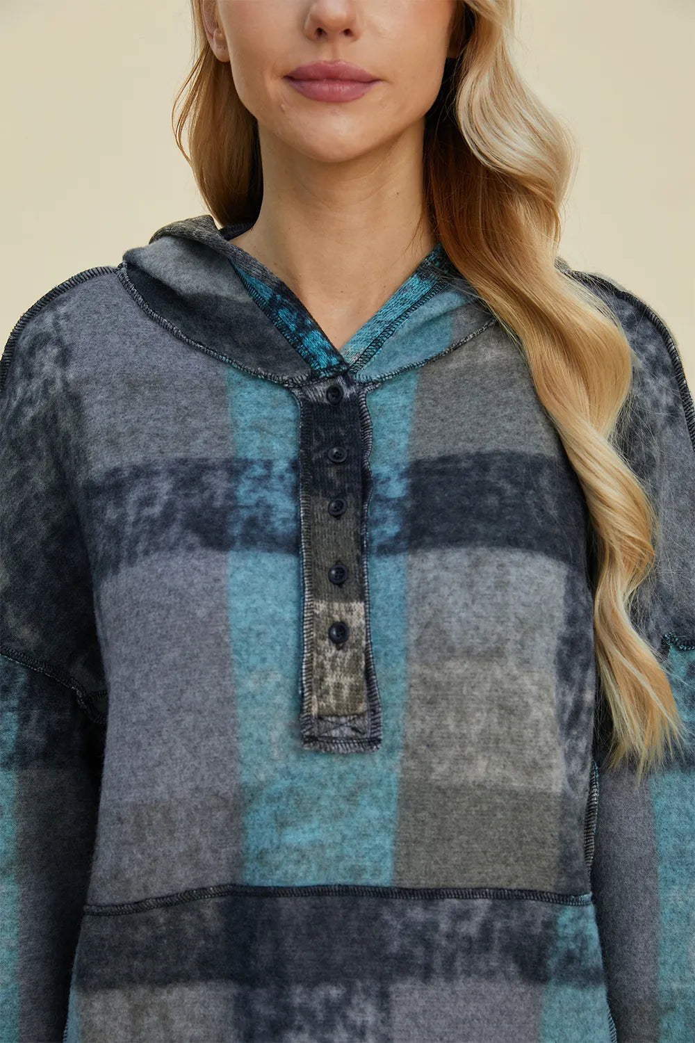 Plaid fleece hoodie with hood and button placket, blue and dark gray, relaxed fit.