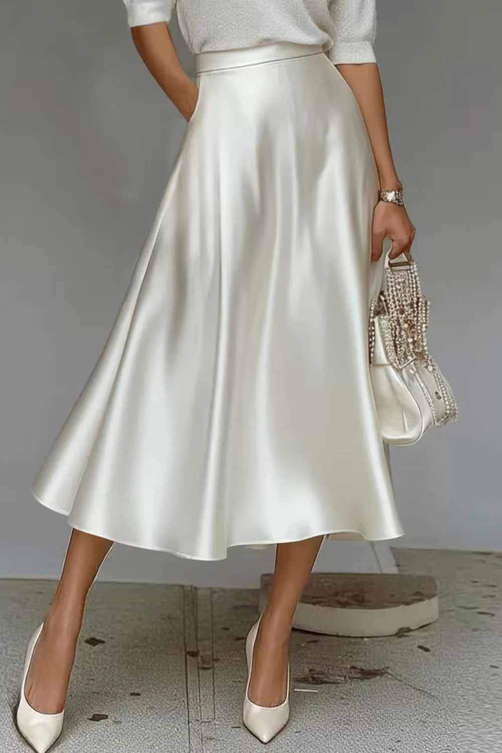White satin A-line midi skirt with side pockets, gathered flare and long midi hem