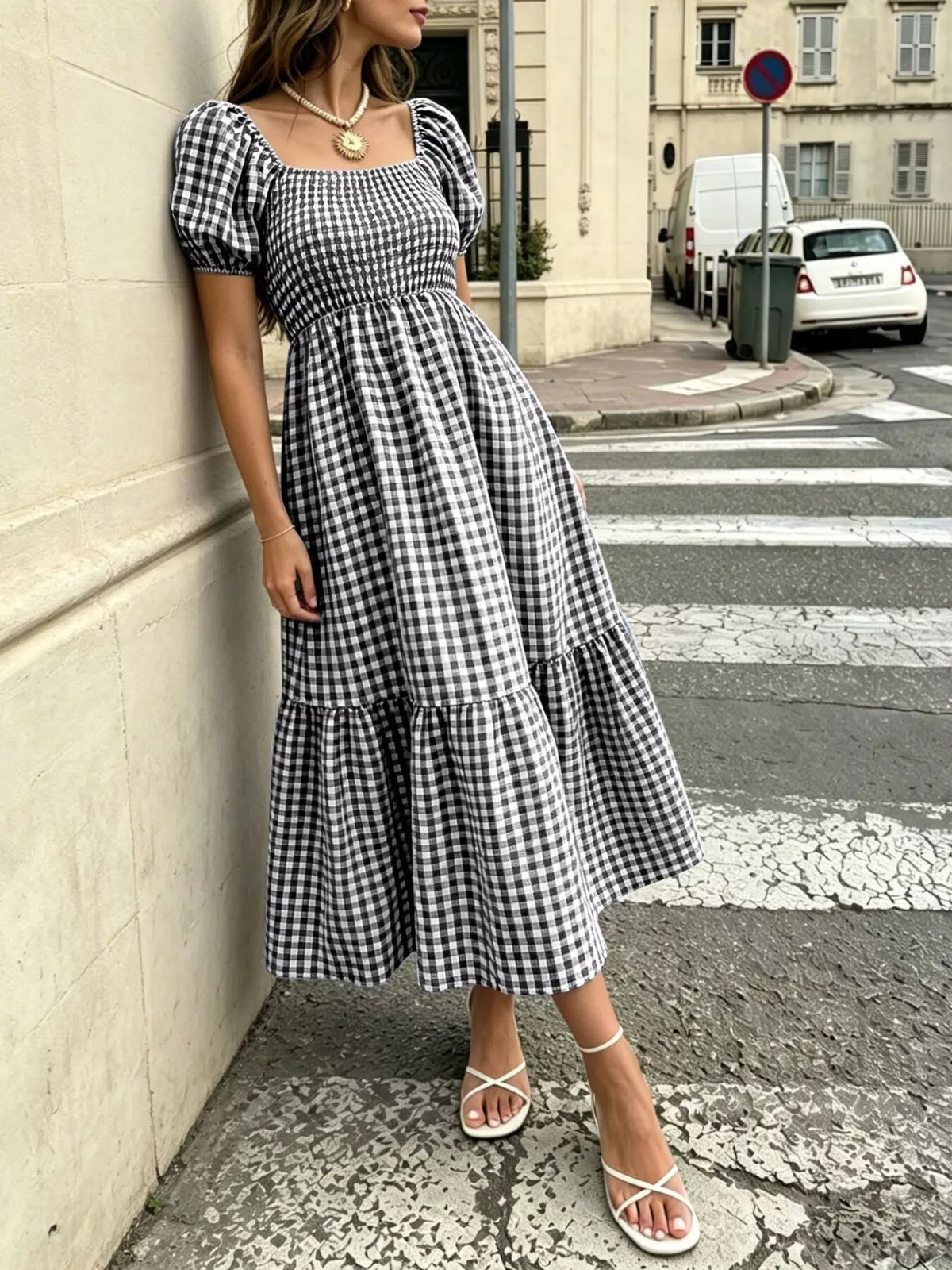 Black and white gingham midi dress with square neckline, puff sleeves, and tiered skirt