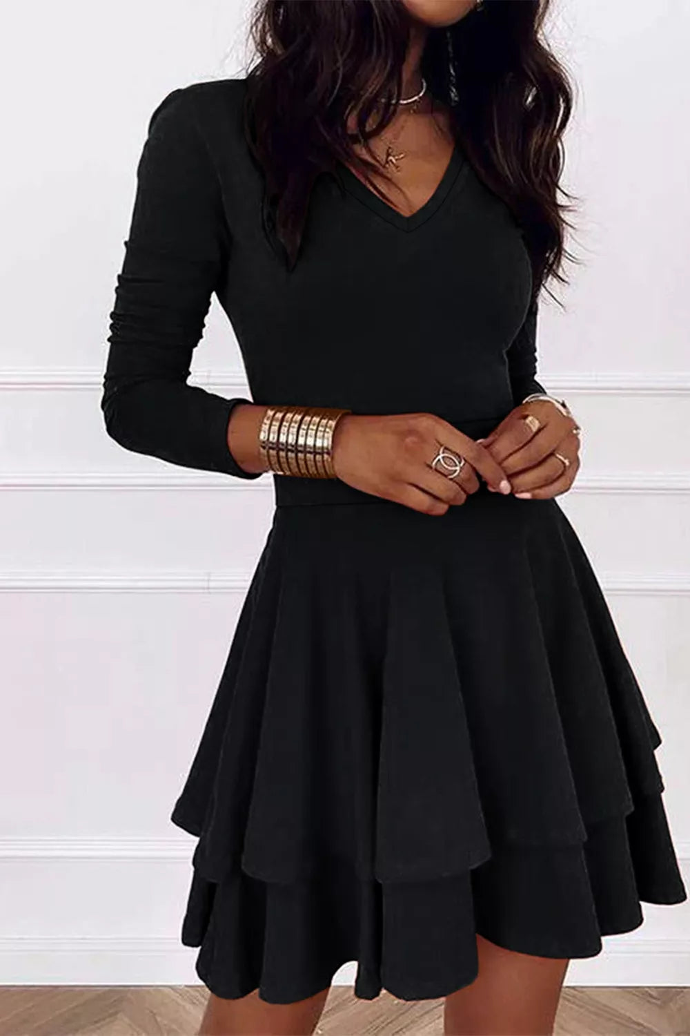 Black long-sleeve V-neck mini dress with layered flared skirt and fitted waist