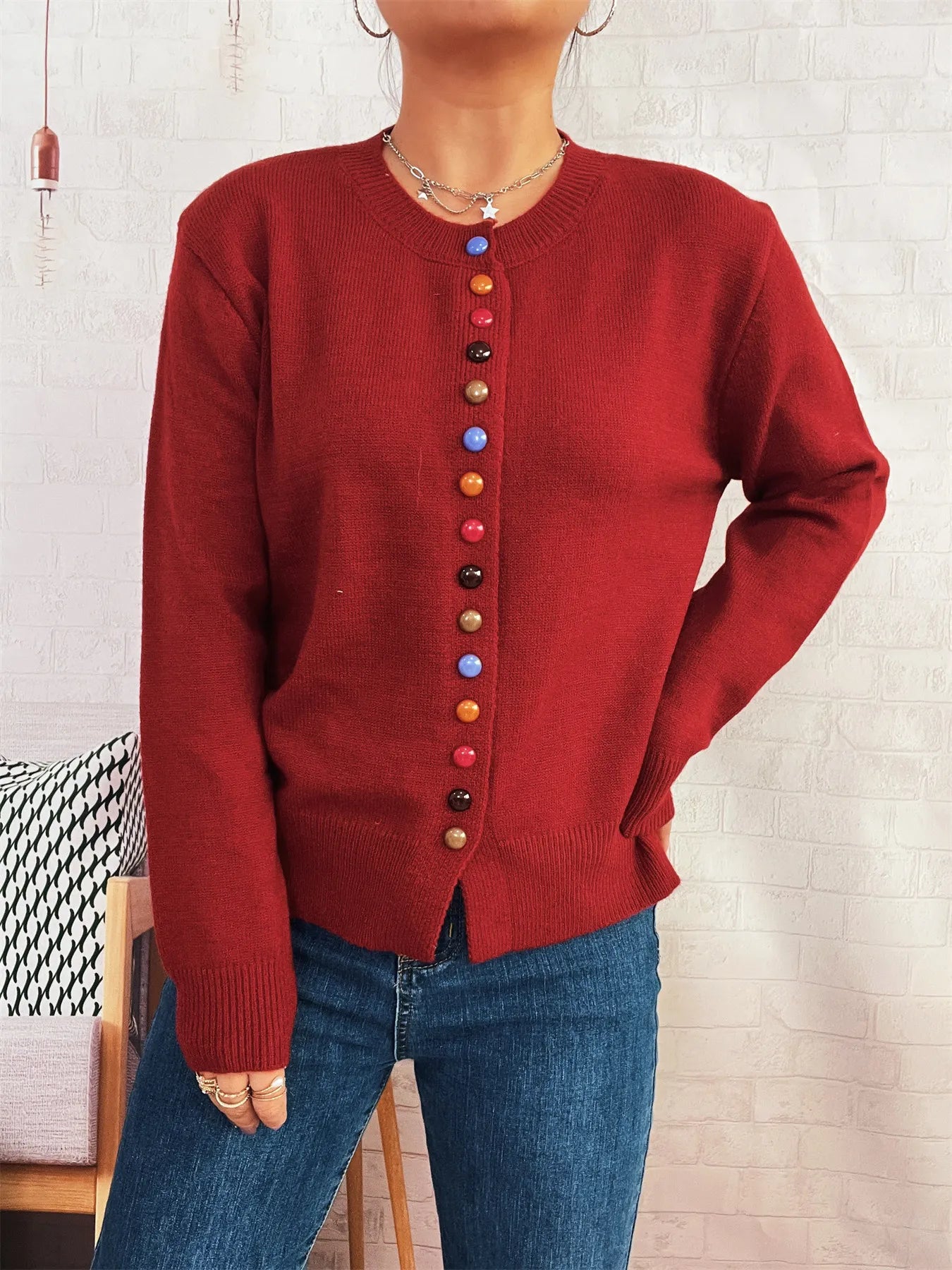 Red button-front cardigan with colorful detail buttons down center, long sleeves