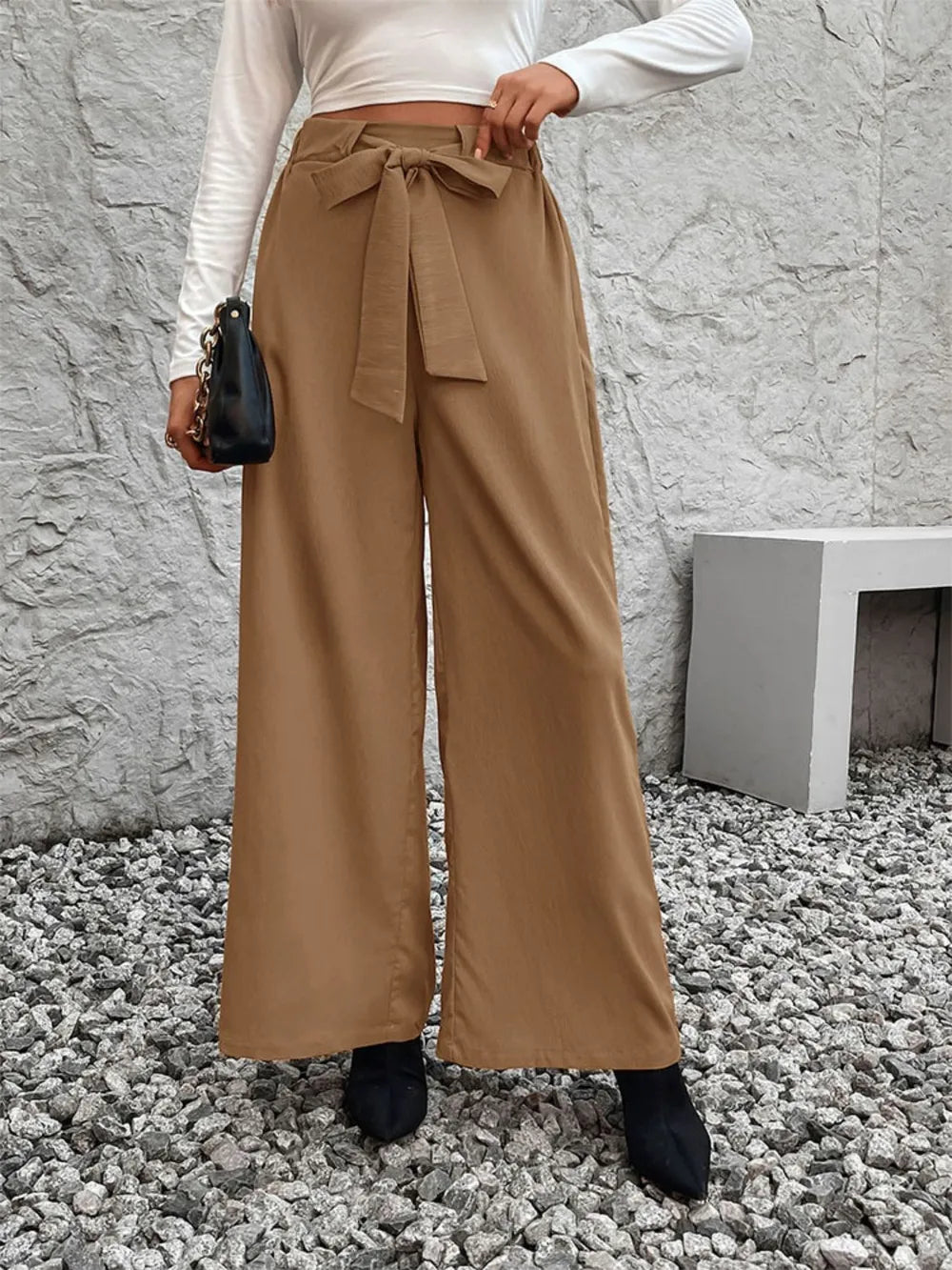 Caramel tied high-waist wide-leg pants with bow belt, full length side stance