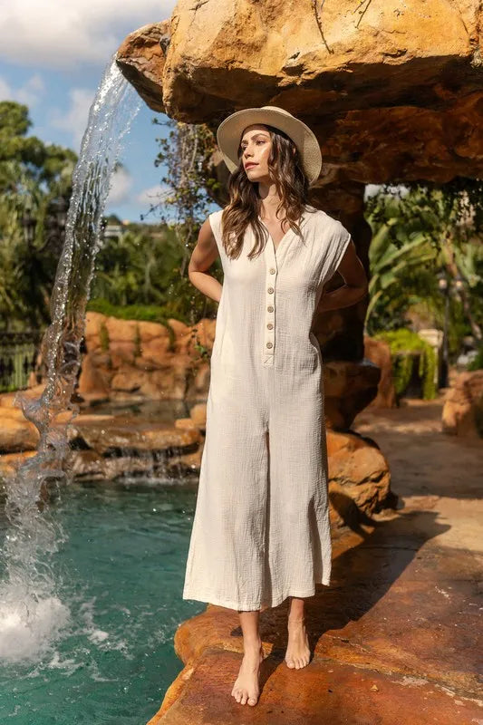 Cream button-front wide-leg jumpsuit with short sleeves and longline fit