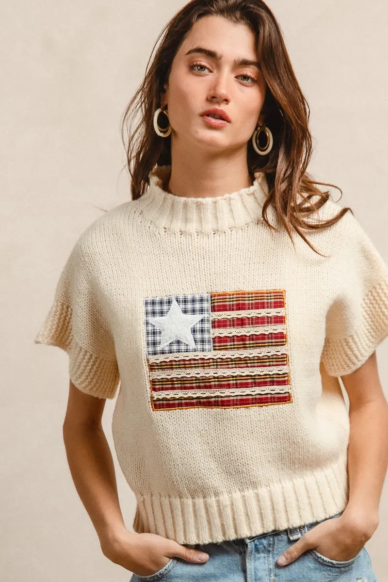 Oatmeal knit sweater with American flag patch, short sleeves, ribbed crew neckline